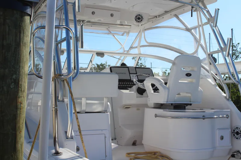 Slide: The Image of 2006 Pro-Line 32 Express boat cockpit with white seating and control panel. - 6