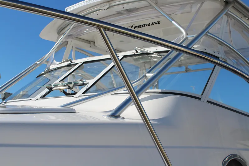 Slide: The Image of 2006 Pro-Line 32 Express boat with sleek design and stainless steel railings. - 9