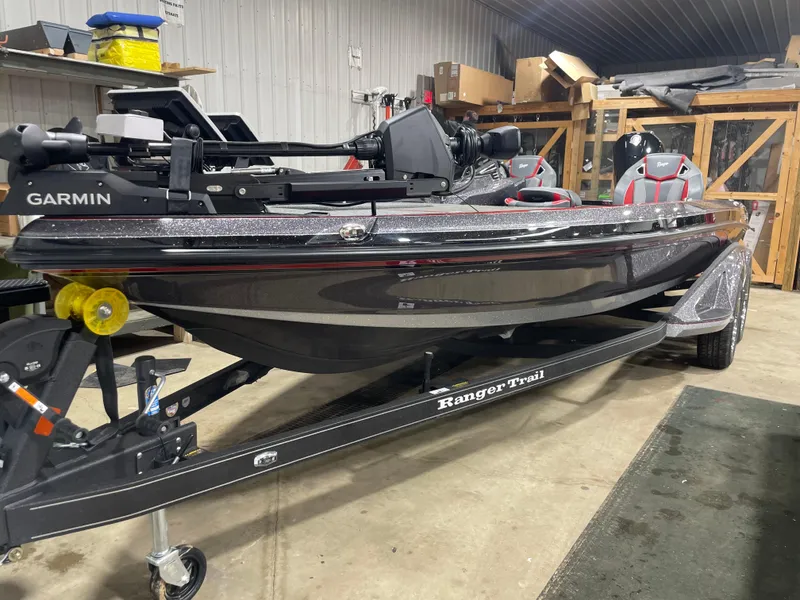 Slide: The Image of 2025 Ranger Z521R Cup-Equipped boat in a garage, featuring Garmin equipment. - 1