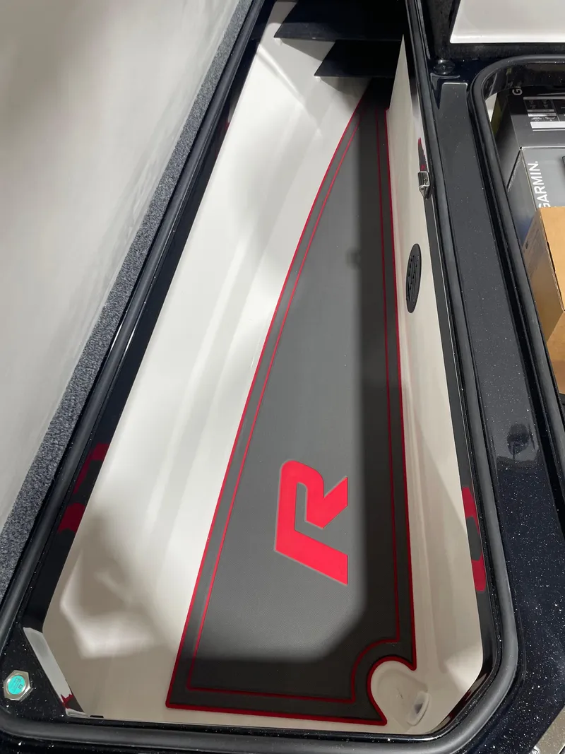 Slide: The Image of 2025 Ranger Z521R Cup-Equipped boat storage compartment with sleek design and logo. - 10