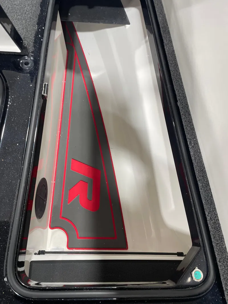 Slide: The Image of 2025 Ranger Z521R Cup-Equipped boat compartment with red "R" logo. - 11