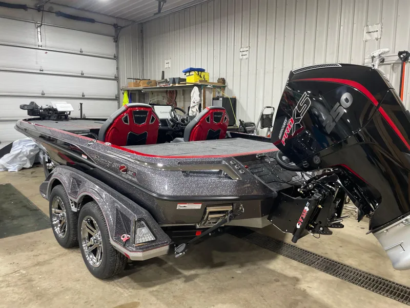 Slide: The Image of 2025 Ranger Z521R Cup-Equipped boat in garage, featuring sleek design and powerful engine. - 3