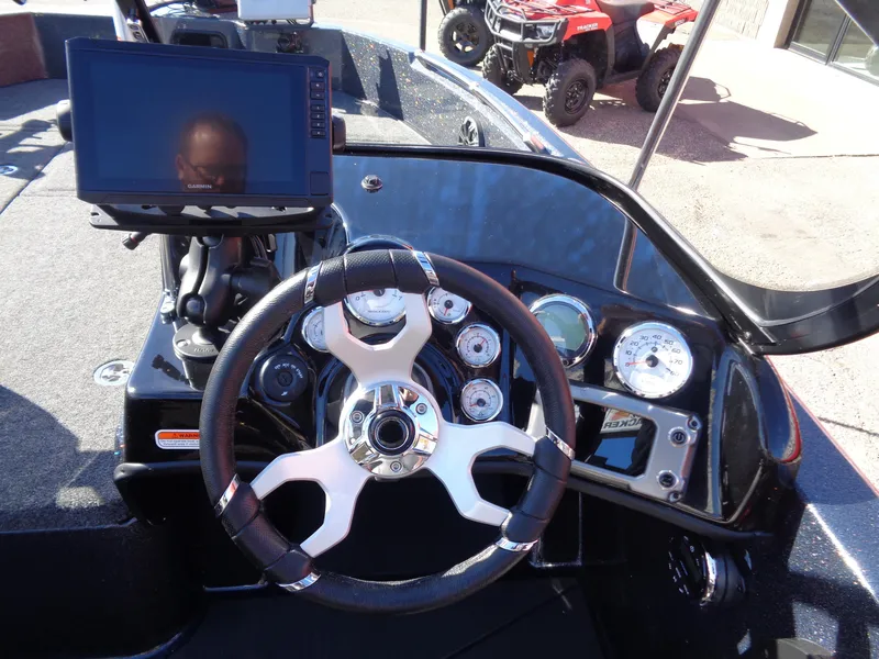 Slide: The Image of 2025 Nitro ZV19 Sport Pro boat dashboard with steering wheel and electronic display. - 10