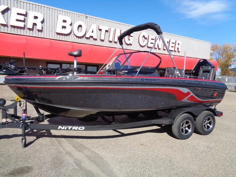 Slide: The Image of 2025 Nitro ZV19 Sport Pro boat at dealership, sleek design, black and red accents. - 2