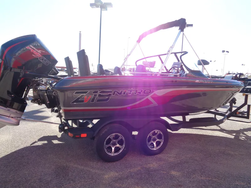 Slide: The Image of 2025 Nitro ZV19 Sport Pro boat with trailer, side view in sunlight. - 4