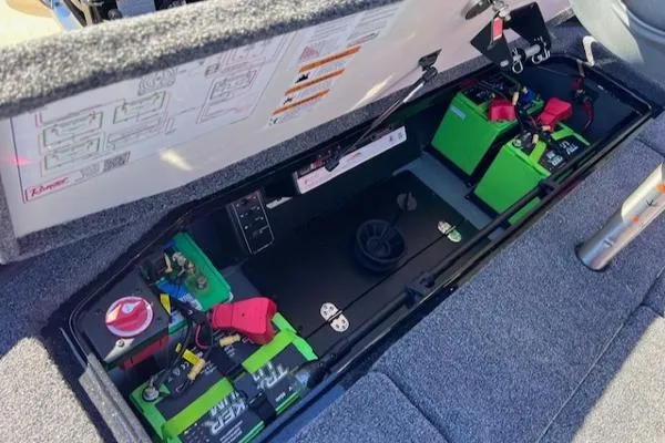 Slide: The Image of 2025 Ranger Z521R Cup-Equipped boat battery compartment with green batteries and wiring. - 15