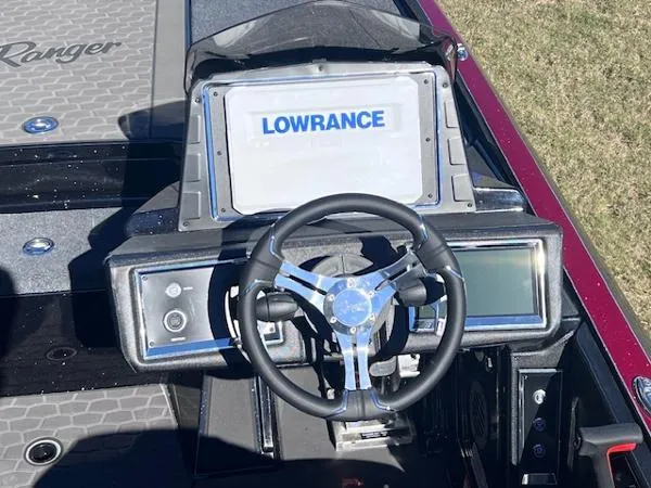 Slide: The Image of 2025 Ranger Z521R Cup-Equipped boat dashboard with Lowrance display and steering wheel. - 8