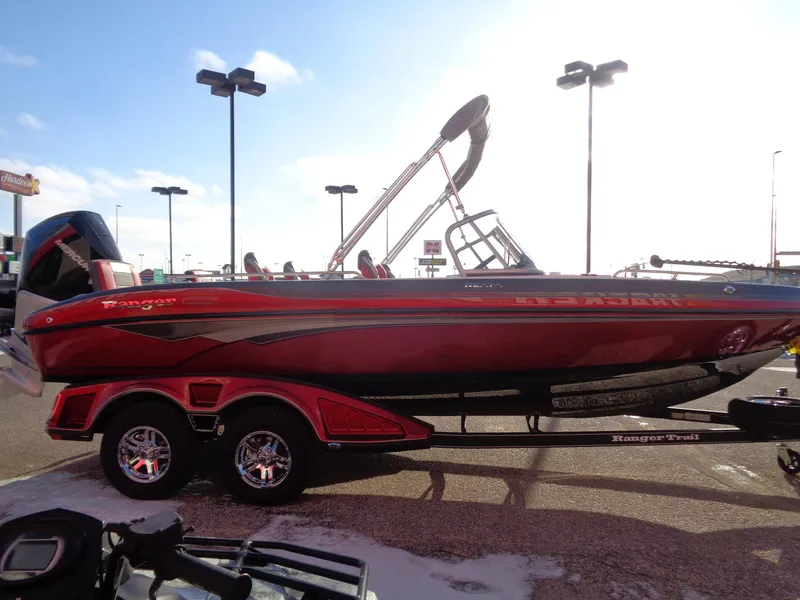 Slide: The Image of Red 2025 Ranger 2050MS boat on trailer in parking lot, sunny day. - 1