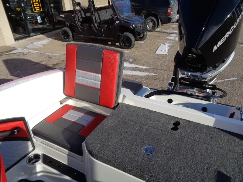 Slide: The Image of 2025 Ranger 2050MS boat interior with red and gray seating, Mercury engine visible. - 14
