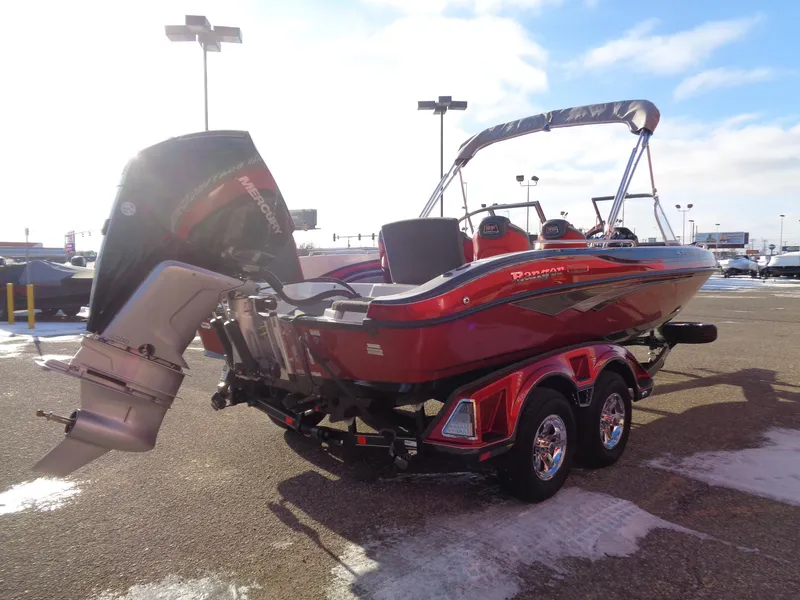 Slide: The Image of Red 2025 Ranger 2050MS boat with outboard motor on a trailer in a parking lot. - 4