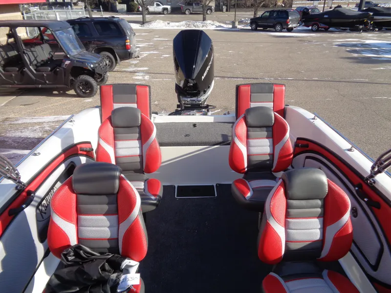 Slide: The Image of 2025 Ranger 2050MS boat interior with red and gray seating, parked outdoors. - 9