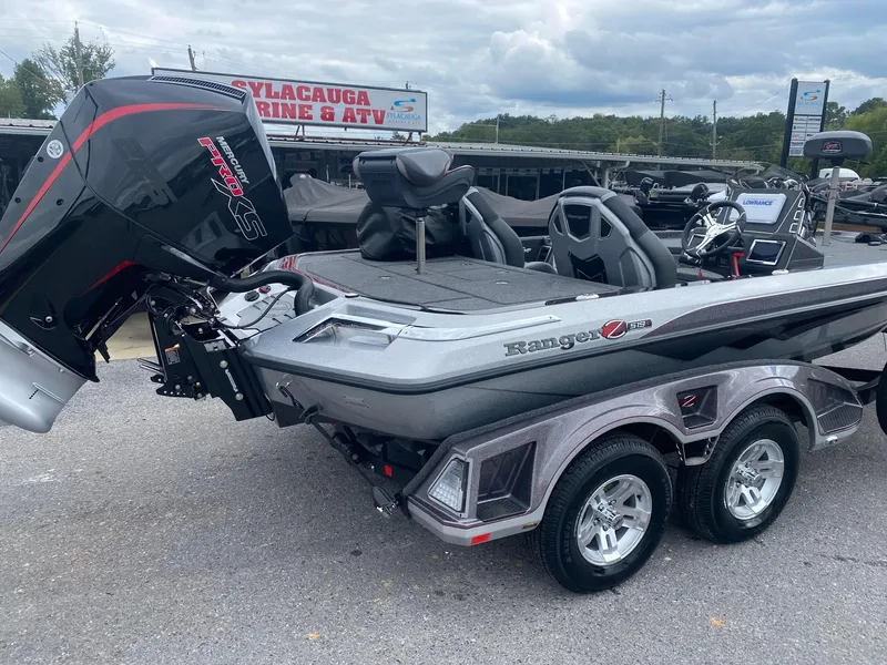 Slide: The Image of 2025 Ranger Z519R boat with powerful outboard motor, parked at Sylacauga Marine & ATV dealership. - 2