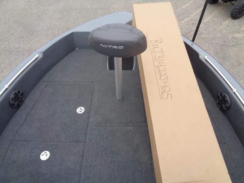 Slide: The Image of 2025 Nitro ZV19 Sport boat deck with seat and cardboard box. - 11