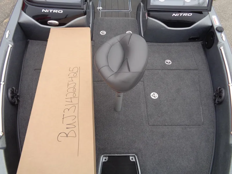 Slide: The Image of 2025 Nitro ZV19 Sport boat interior with seat and cardboard box. - 12