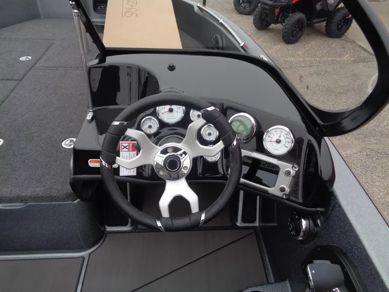 Slide: The Image of 2025 Nitro ZV19 Sport boat dashboard with steering wheel and gauges. - 8