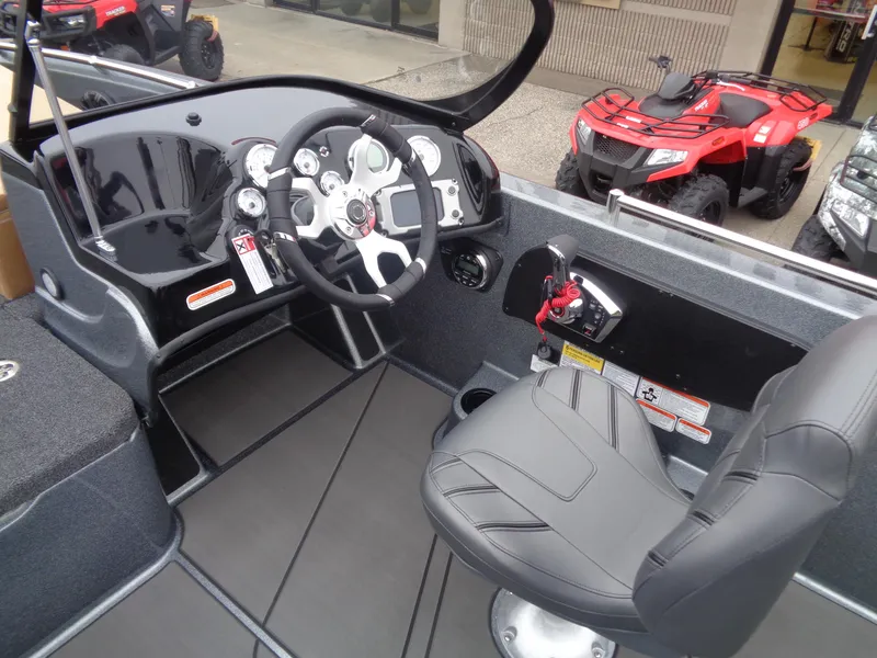 Slide: The Image of 2025 Nitro ZV19 Sport boat interior with steering wheel and seat. - 9