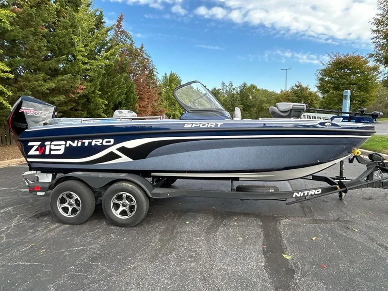 Slide: The Image of 2025 Nitro ZV19 Sport boat on trailer, parked outdoors with trees in the background. - 3
