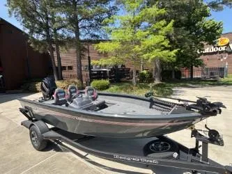 Slide: The Image of 2025 Ranger VS1665SC fishing boat on trailer in parking lot. - 2