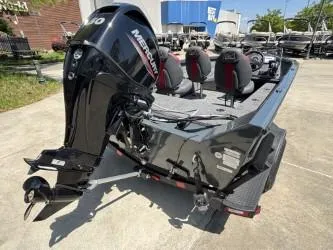 Slide: The Image of 2025 Ranger VS1665SC boat on trailer, parked outdoors near trees and buildings. - 3