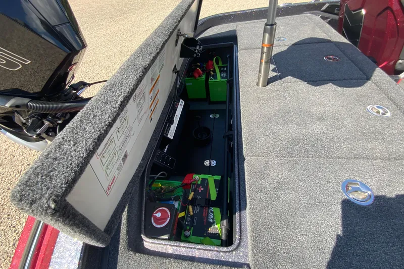 Slide: The Image of Open storage compartment in 2025 Ranger Z521R boat, revealing batteries and equipment. - 19