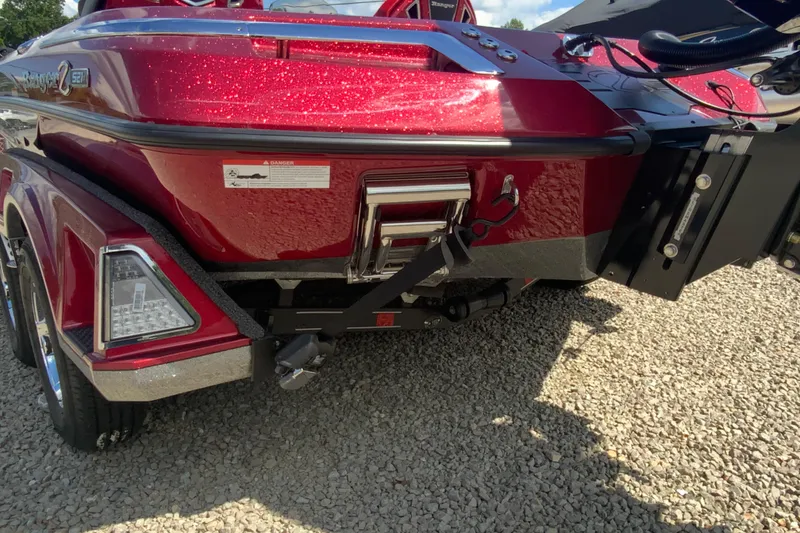 Slide: The Image of 2025 Ranger Z521R boat rear view with red metallic finish on gravel surface. - 7