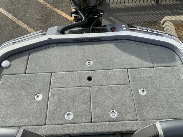 Slide: The Image of 2025 Ranger Z521R Cup-Equipped boat deck with gray carpet and storage compartments. - 10