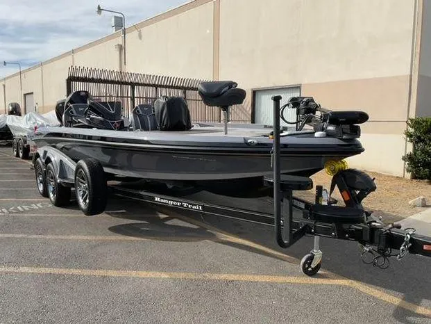 Slide: The Image of 2025 Ranger Z521R Cup-Equipped boat on trailer, parked outdoors. - 2