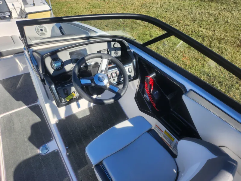 Slide: The Image of 2023 Yamaha AR190 boat cockpit with steering wheel and dashboard controls. - 11