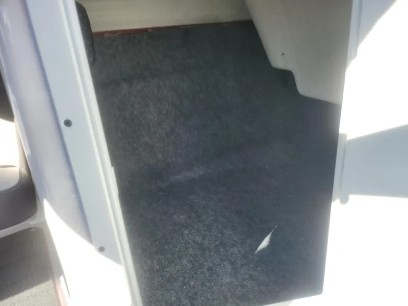 Slide: The Image of Interior view of 2023 Yamaha AR190 boat storage compartment with carpeted flooring. - 14