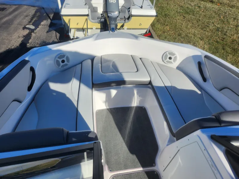 Slide: The Image of 2023 Yamaha AR190 boat interior with cushioned seating and speakers. - 16