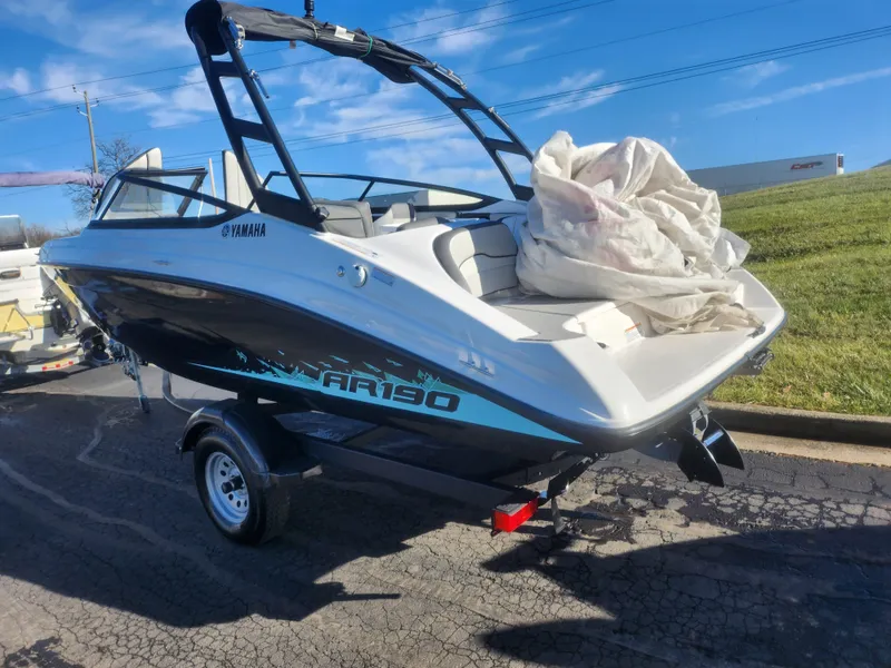 Slide: The Image of 2023 Yamaha AR190 boat on trailer, parked outdoors under clear blue sky. - 3