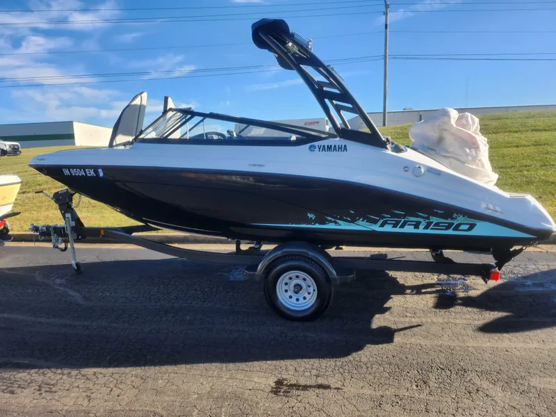 Slide: The Image of 2023 Yamaha AR190 boat on trailer, sleek design, black and white color scheme. - 4
