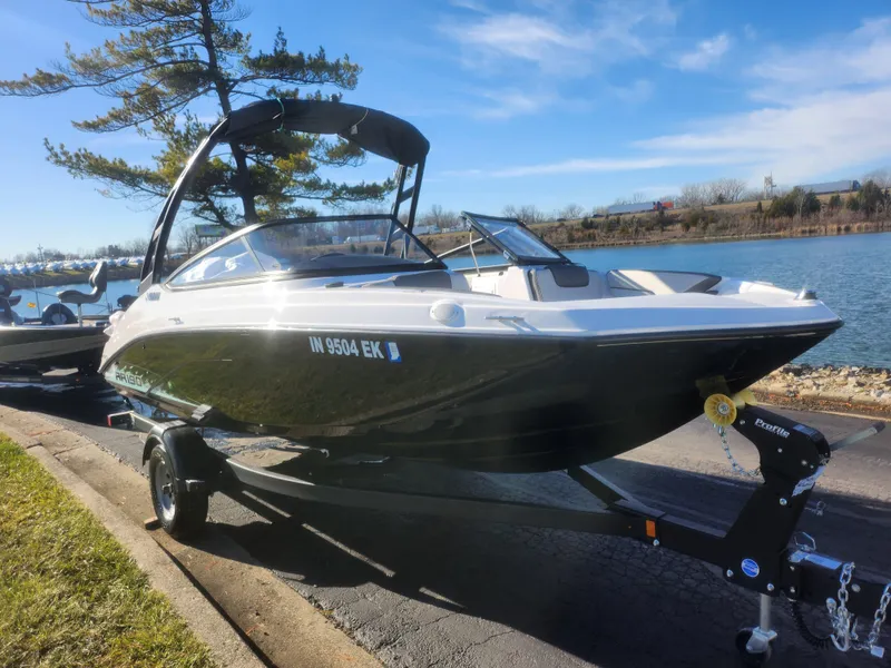 Slide: The Image of 2023 Yamaha AR190 boat on trailer by a lake, under clear blue sky. - 8