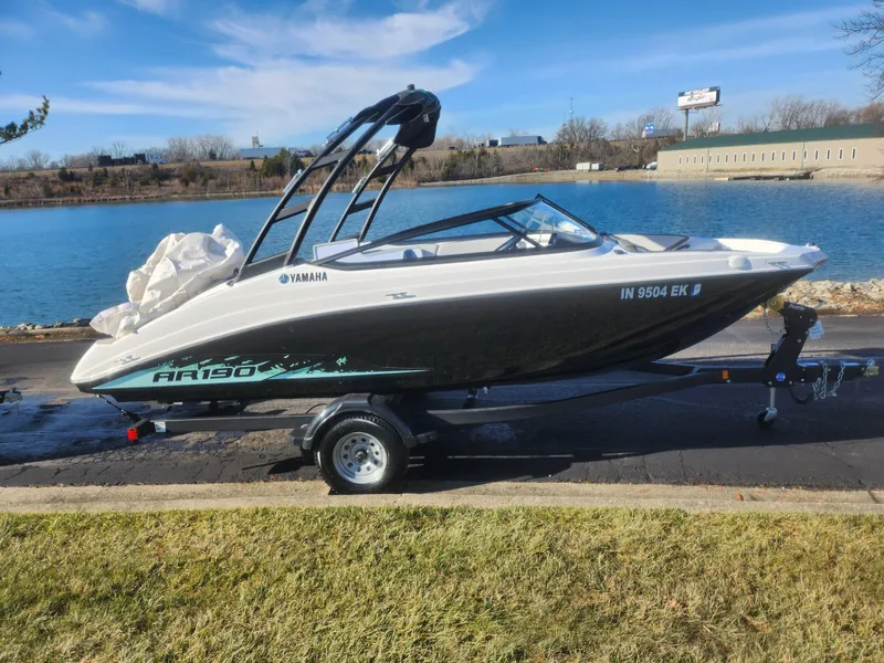 Slide: The Image of 2023 Yamaha AR190 boat on trailer by a lake. - 9