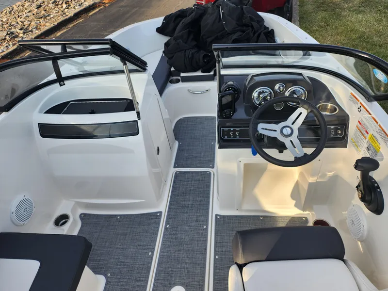 Slide: The Image of 2022 Bayliner VR4 Bowrider OB interior with steering wheel and seating area. - 11