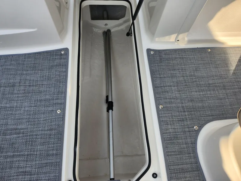 Slide: The Image of 2022 Bayliner VR4 Bowrider OB interior storage compartment with carpeted flooring. - 12