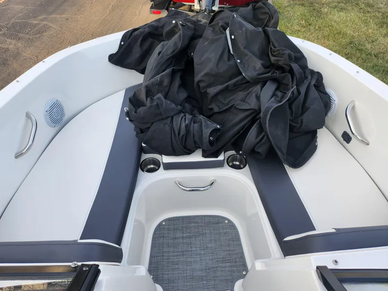 Slide: The Image of 2022 Bayliner VR4 Bowrider OB interior with black cover and seating area. - 16