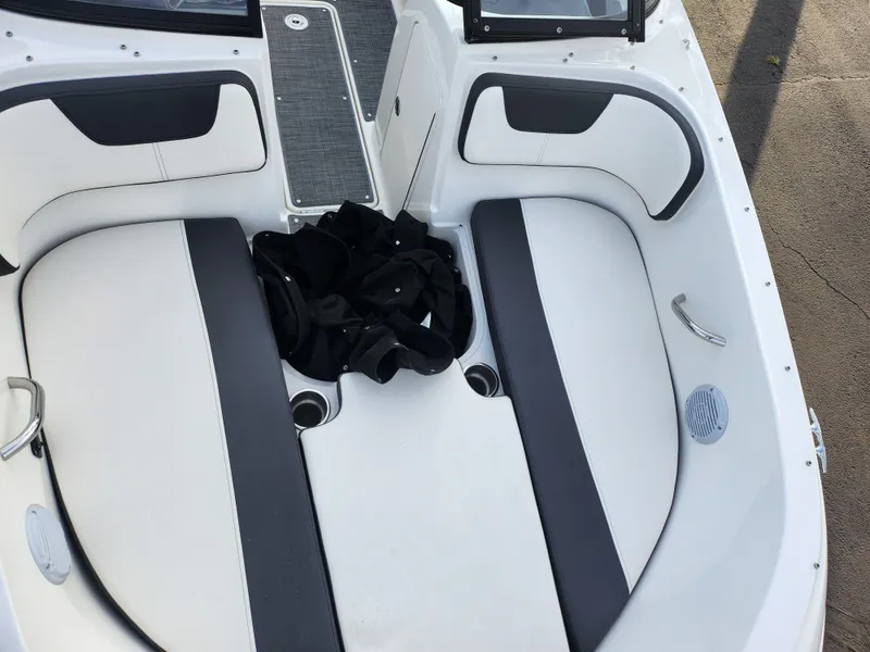 Slide: The Image of 2022 Bayliner VR4 Bowrider OB interior with cushioned seating and storage space. - 17