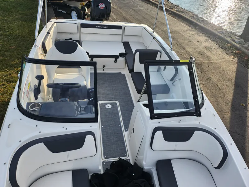 Slide: The Image of 2022 Bayliner VR4 Bowrider OB interior with seating and steering wheel, docked by the water. - 18