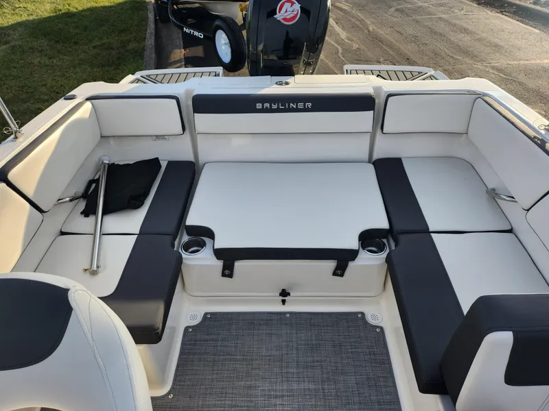 Slide: The Image of 2022 Bayliner VR4 Bowrider OB interior with cushioned seating and cup holders. - 20