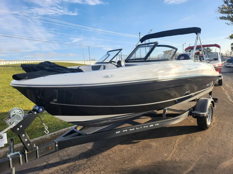 Slide: The Image of 2022 Bayliner VR4 Bowrider OB on trailer, parked outdoors under clear sky. - 5