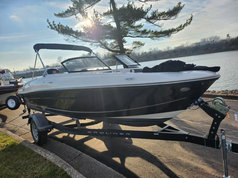 Slide: The Image of 2022 Bayliner VR4 Bowrider OB on trailer by a lake, sunny day. - 8