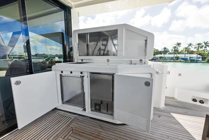 Slide: The Image of Outdoor kitchen on 2017 Azimut 77S yacht with open cabinets and ocean view. - 34