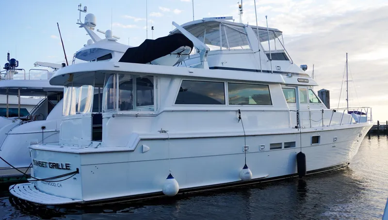 Slide: The Image of 1990 Hatteras 62 Cockpit Motor Yacht docked at marina, side view. - 1