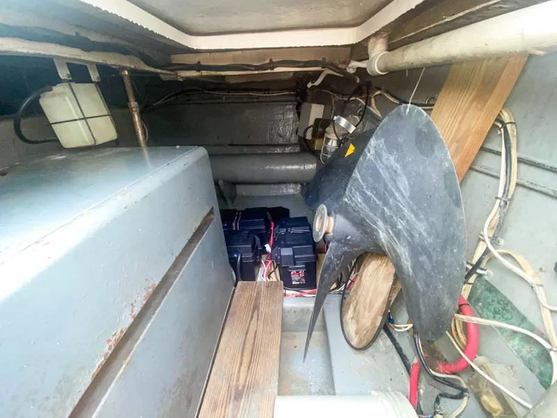Slide: The Image of Engine room of 1990 Hatteras 62 Cockpit Motor Yacht with batteries and propeller. - 12