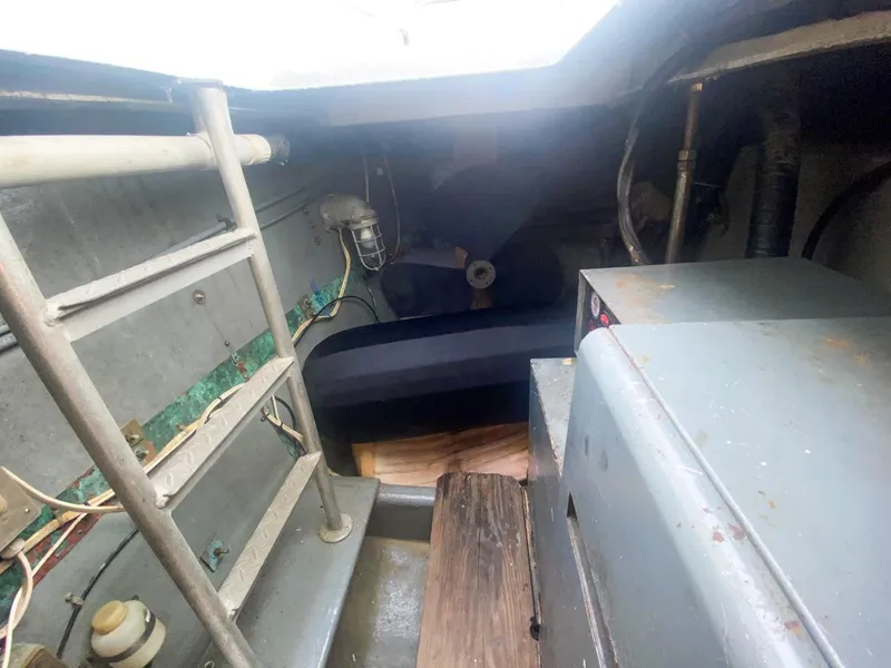 Slide: The Image of Interior of 1990 Hatteras 62 Cockpit Motor Yacht engine room, showing equipment and ladder. - 15