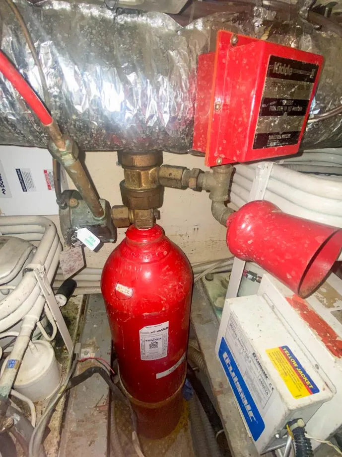 Slide: The Image of Engine room of 1990 Hatteras 62 Cockpit Motor Yacht with fire suppression system. - 16