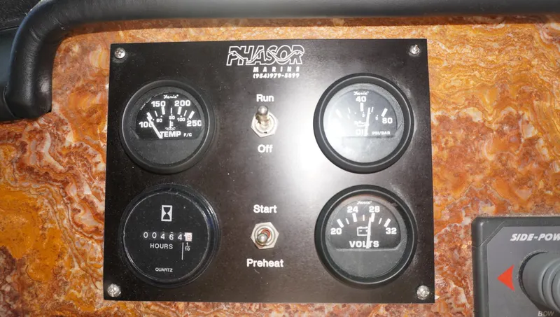 Slide: The Image of Control panel of a 1990 Hatteras 62 Cockpit Motor Yacht with gauges and switches. - 17