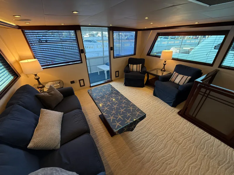 Slide: The Image of Luxurious interior of 1990 Hatteras 62 Cockpit Motor Yacht with elegant seating and decor. - 33
