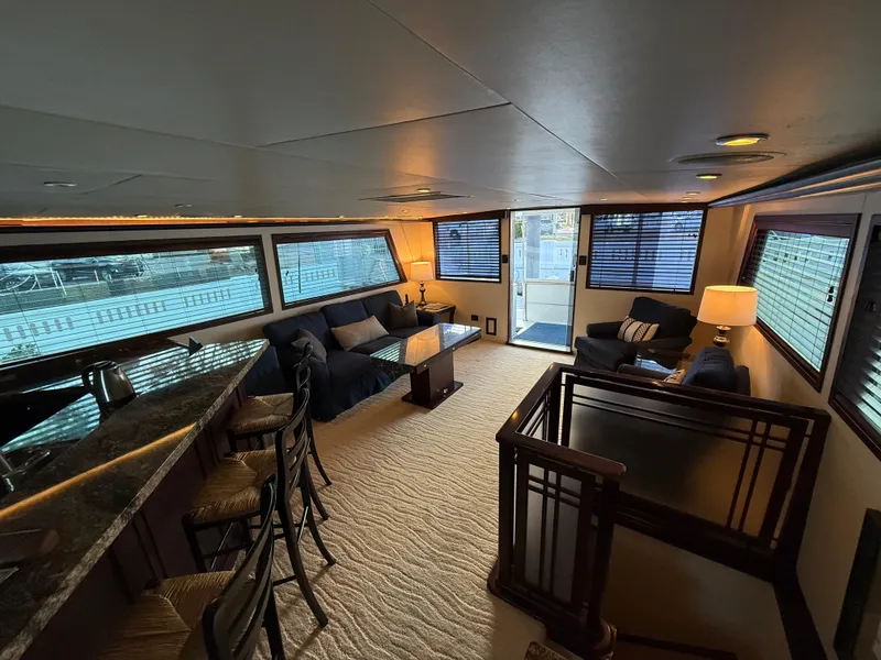 Slide: The Image of Luxurious interior of 1990 Hatteras 62 Cockpit Motor Yacht with elegant seating and bar area. - 35
